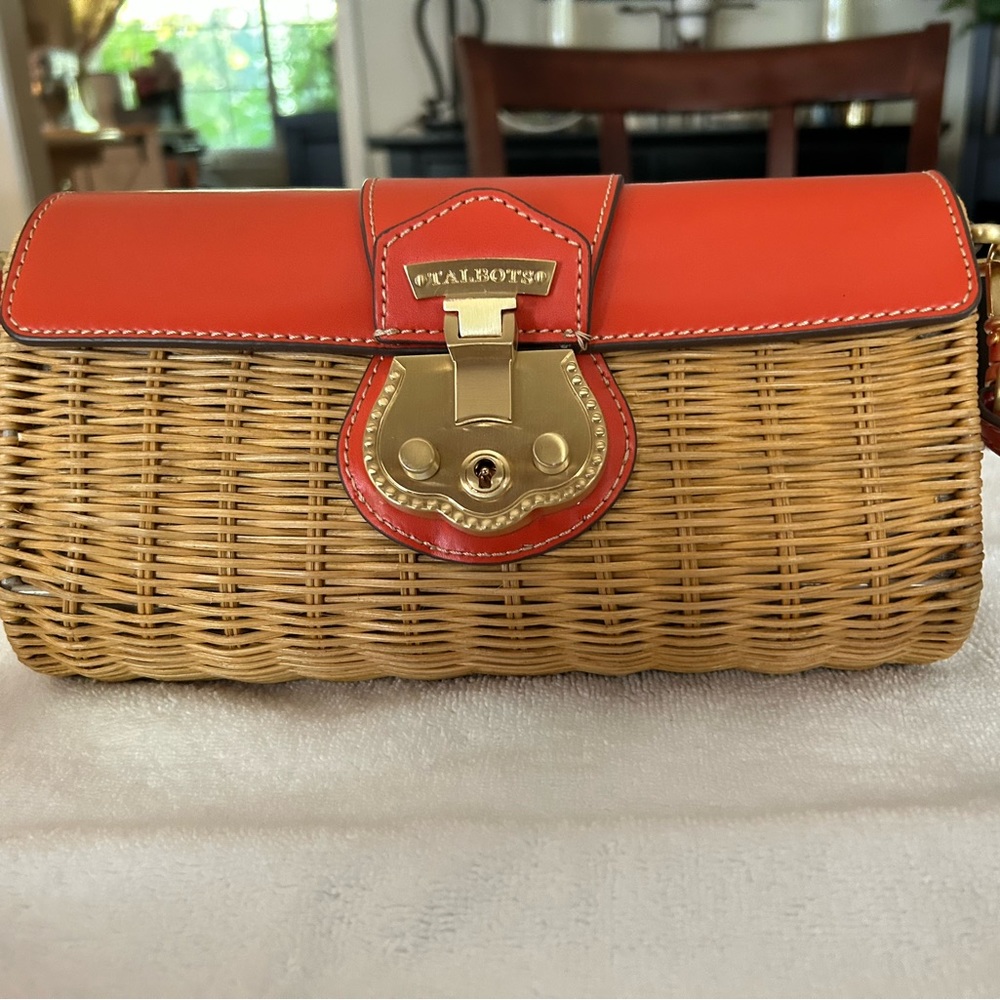 Talbot’s small wicker crossbody bag with orange leather accents.
